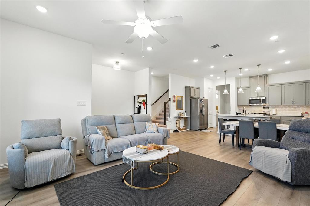 6535 Baritone Court Sachse, TX 75048 - Photo 3 of 24 a living room with furniture and kitchen view