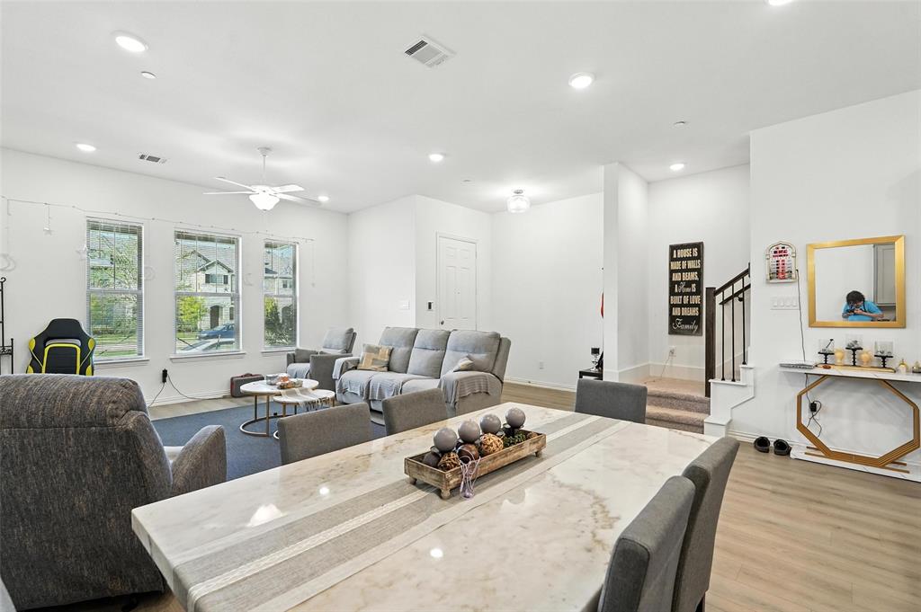 6535 Baritone Court Sachse, TX 75048 - Photo 6 of 24 a living room with furniture wooden floor and a table