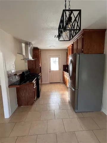 a kitchen with a refrigerator and a sink