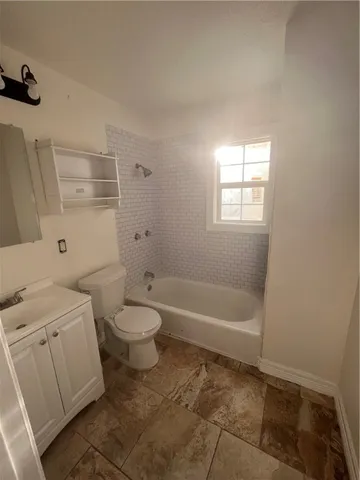 a bathroom with a toilet a sink and bathtub