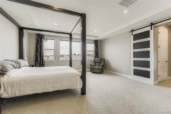 a bedroom with bed and a large window