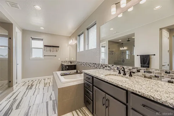 a bathroom with a sink double vanity granite and a mirror