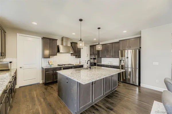 a kitchen with a stove sink and refrigerator