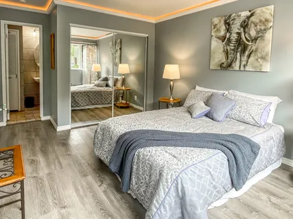 a bedroom with a bed and a lamp next to a window