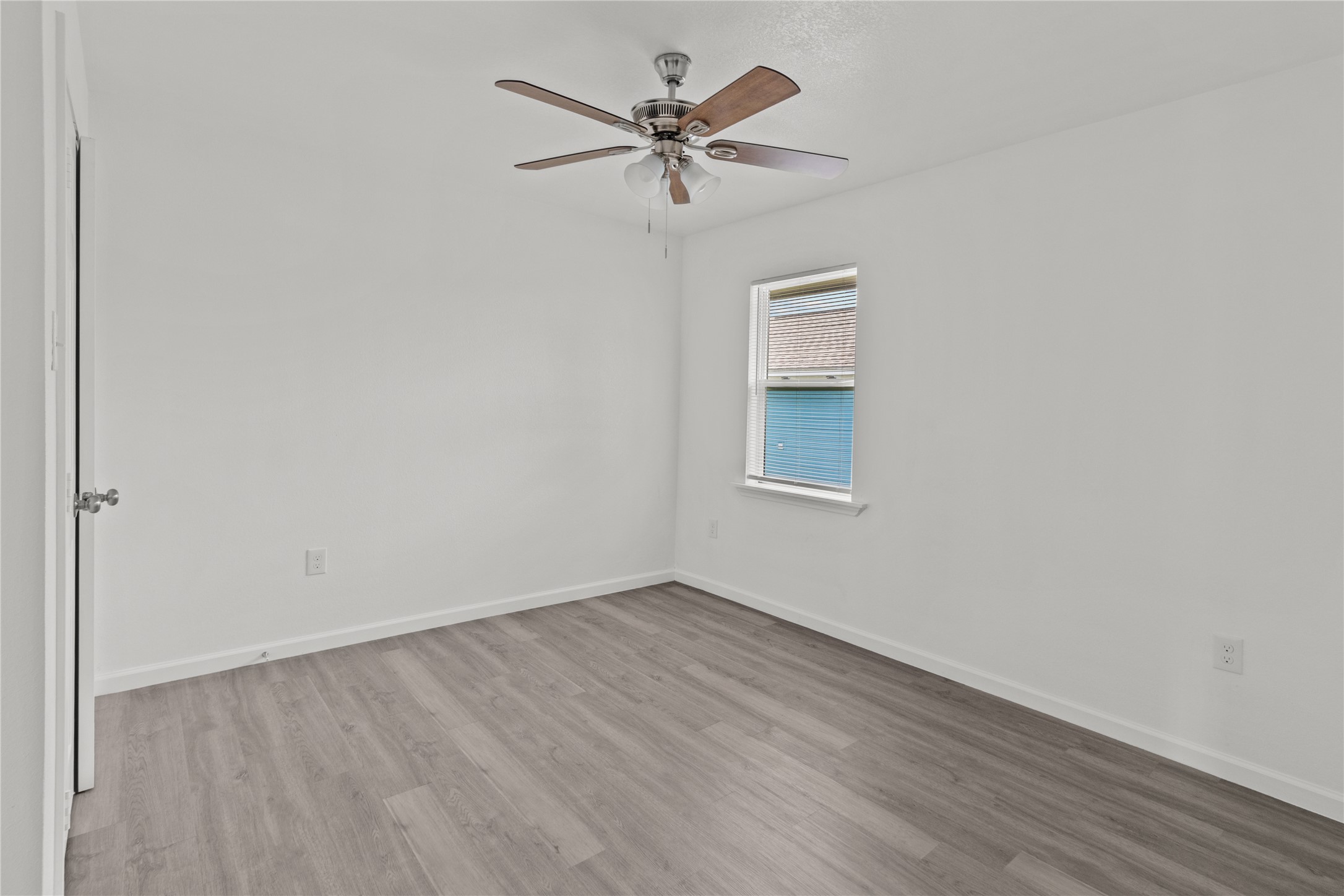316 20th Street, Unit B San Leon, TX 77539 - Photo 3 of 11 an empty room with wooden floor and ceiling fan
