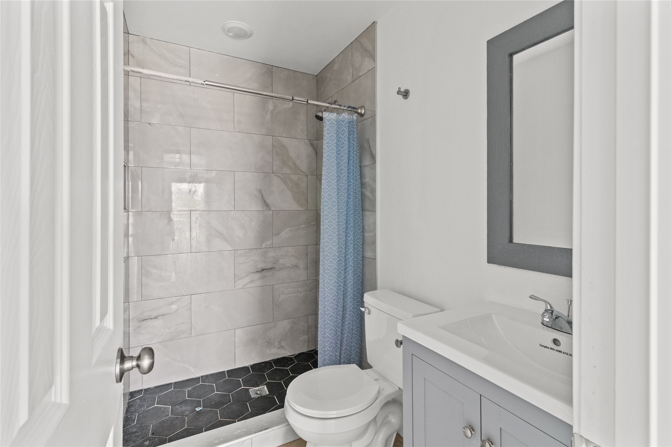 316 20th Street, Unit B San Leon, TX 77539 - Photo 4 of 11 a bathroom with a sink a toilet and shower