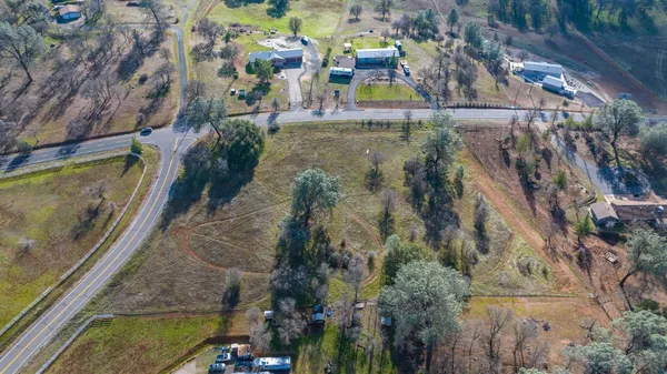 an aerial view of a residential houses with outdoor space