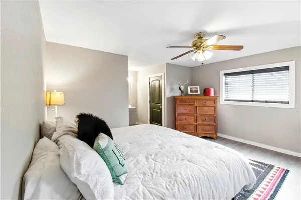 a bedroom with a bed dresser and a window