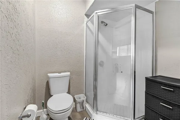 a white toilet sitting next to a bathroom sink