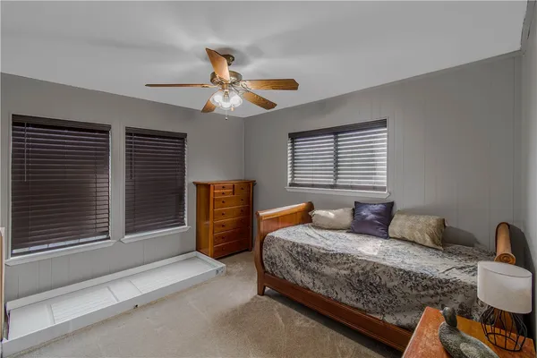 a bedroom with bed and wooden floor