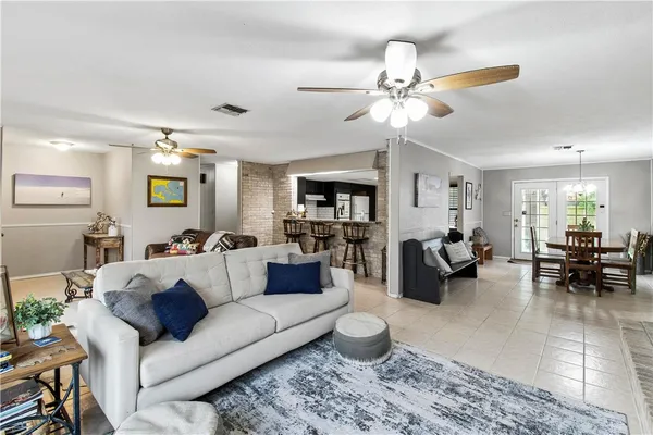 a living room with furniture and view of kitchen