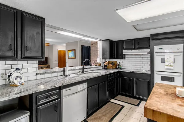 a kitchen with a sink stainless steel appliances and cabinets