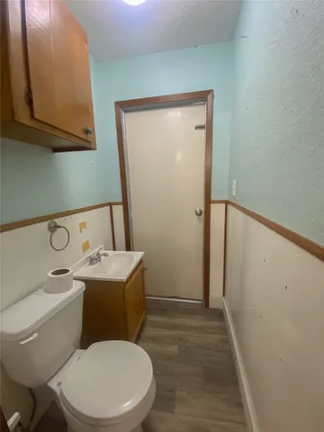 a white toilet sitting next to a bathroom sink