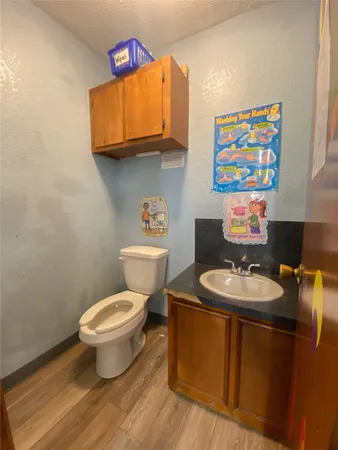 a bathroom with a toilet a sink and a mirror