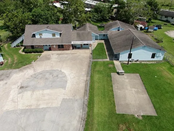 an aerial view of a house with a yard