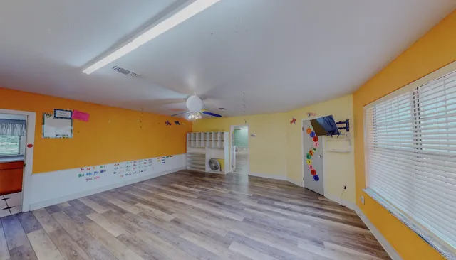 a view of a hallway with wooden floor