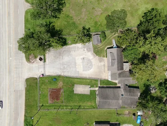 an aerial view of a house with a yard
