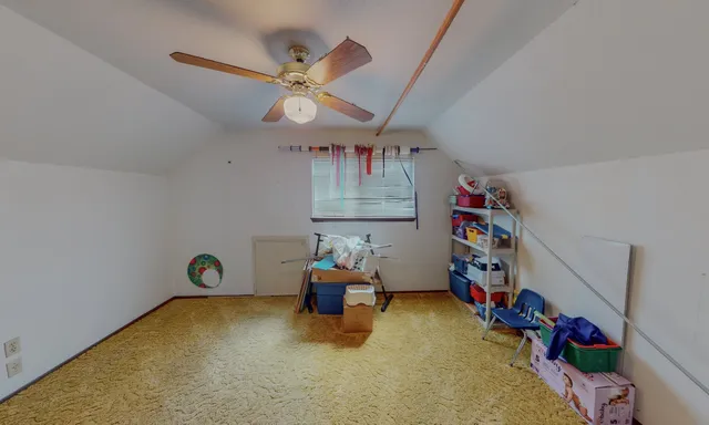 a bedroom with toys and a chandelier