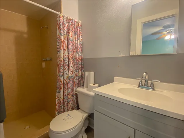 a bathroom with a sink a toilet and vanity