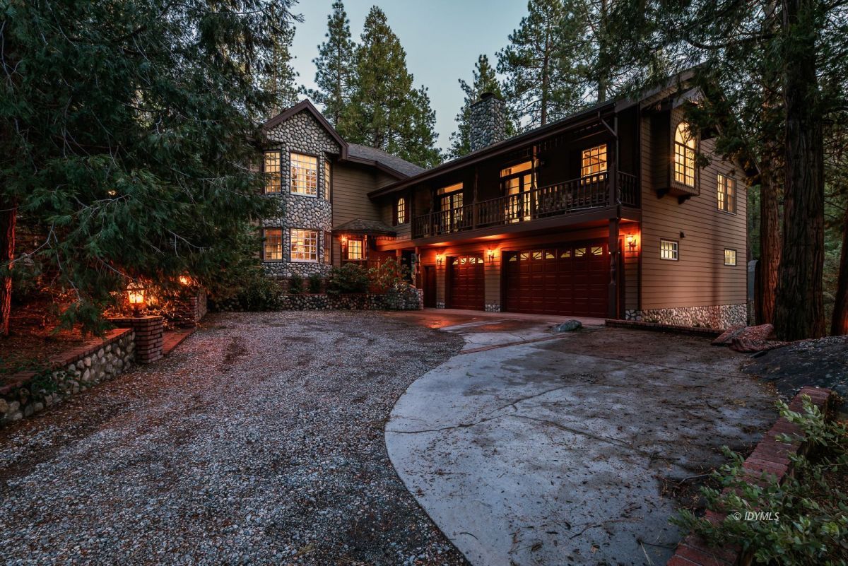 a view of a house with a yard and tree s