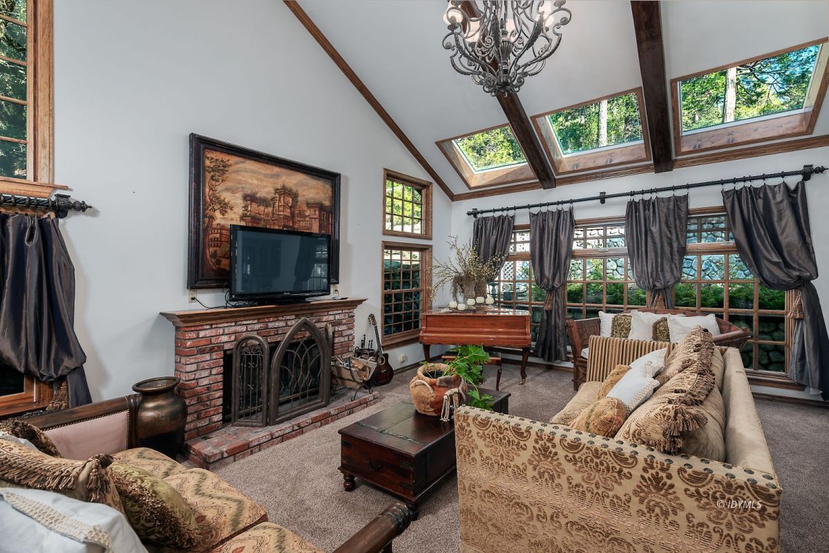 52595 Idyllmont Road Idyllwild, CA 92549 - Photo 25 of 58 a living room with furniture a flat screen tv and a fireplace