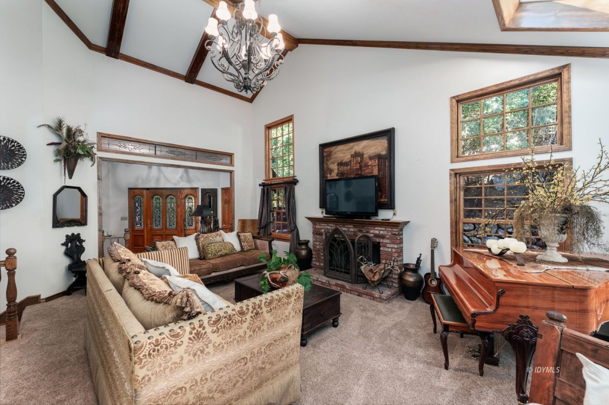 52595 Idyllmont Road Idyllwild, CA 92549 - Photo 26 of 58 a living room with fireplace furniture and a flat screen tv
