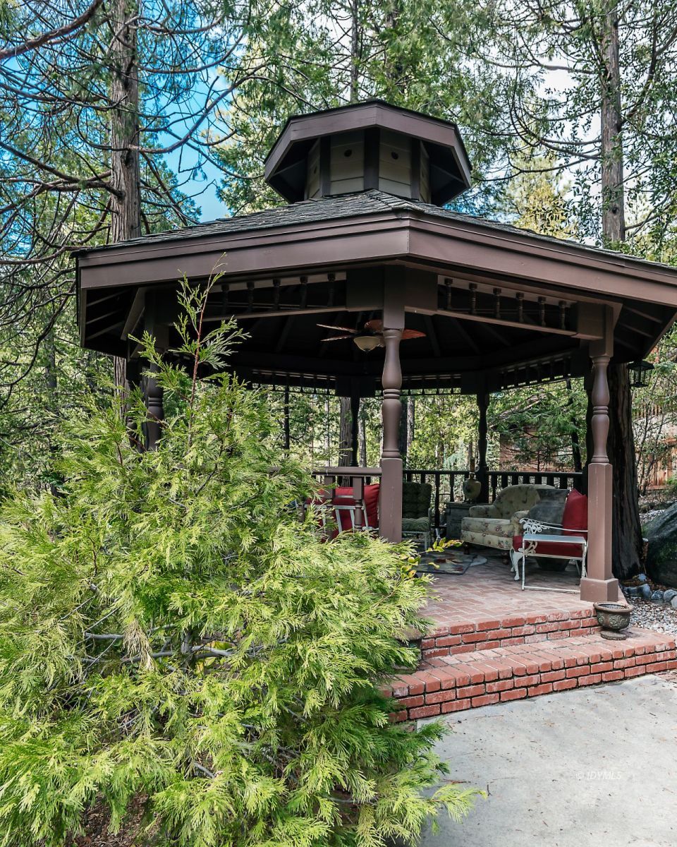 52595 Idyllmont Road Idyllwild, CA 92549 - Photo 4 of 58 a view of a chair and table under an umbrella