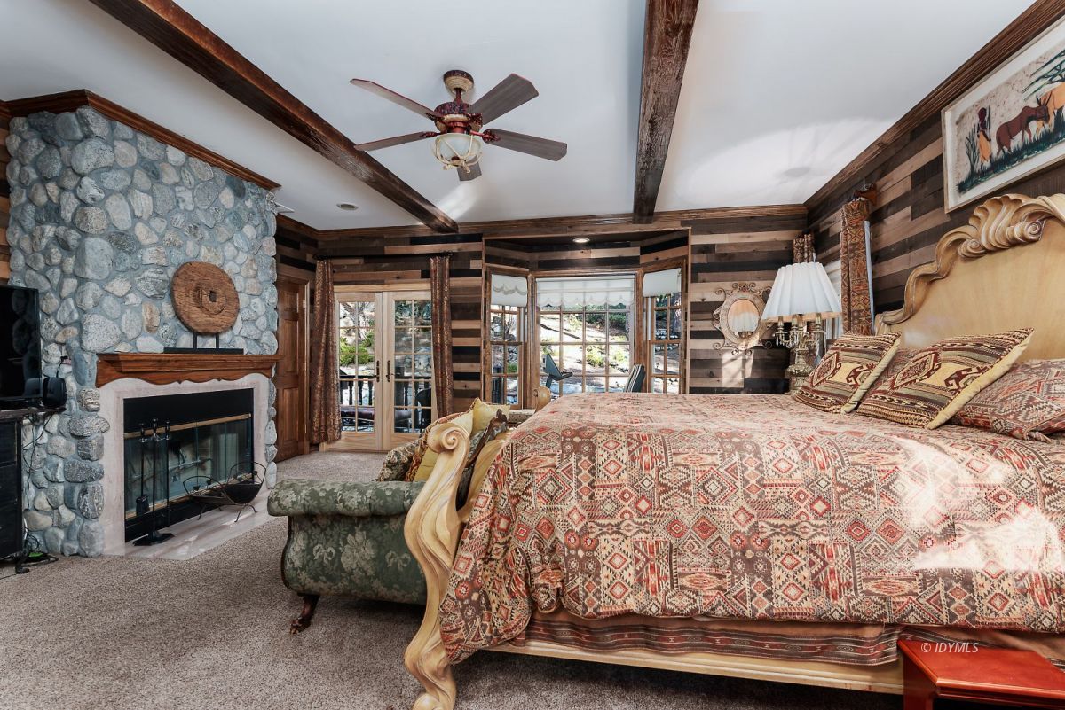 52595 Idyllmont Road Idyllwild, CA 92549 - Photo 34 of 58 a bed sitting in a room next to a fireplace