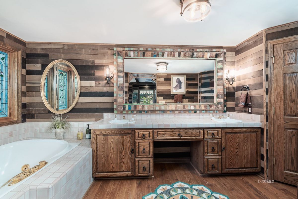 52595 Idyllmont Road Idyllwild, CA 92549 - Photo 35 of 58 a bathroom with a double vanity sink and a bathtub