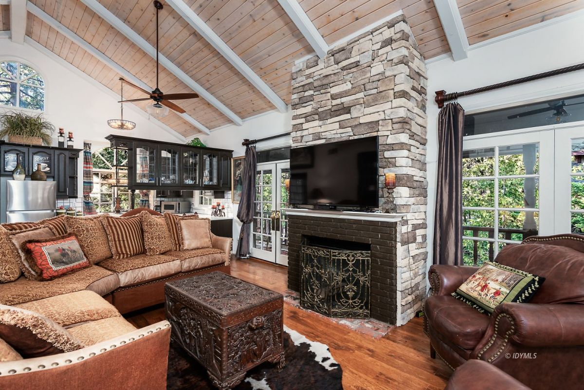 52595 Idyllmont Road Idyllwild, CA 92549 - Photo 43 of 58 a living room with furniture a flat screen tv and a fireplace