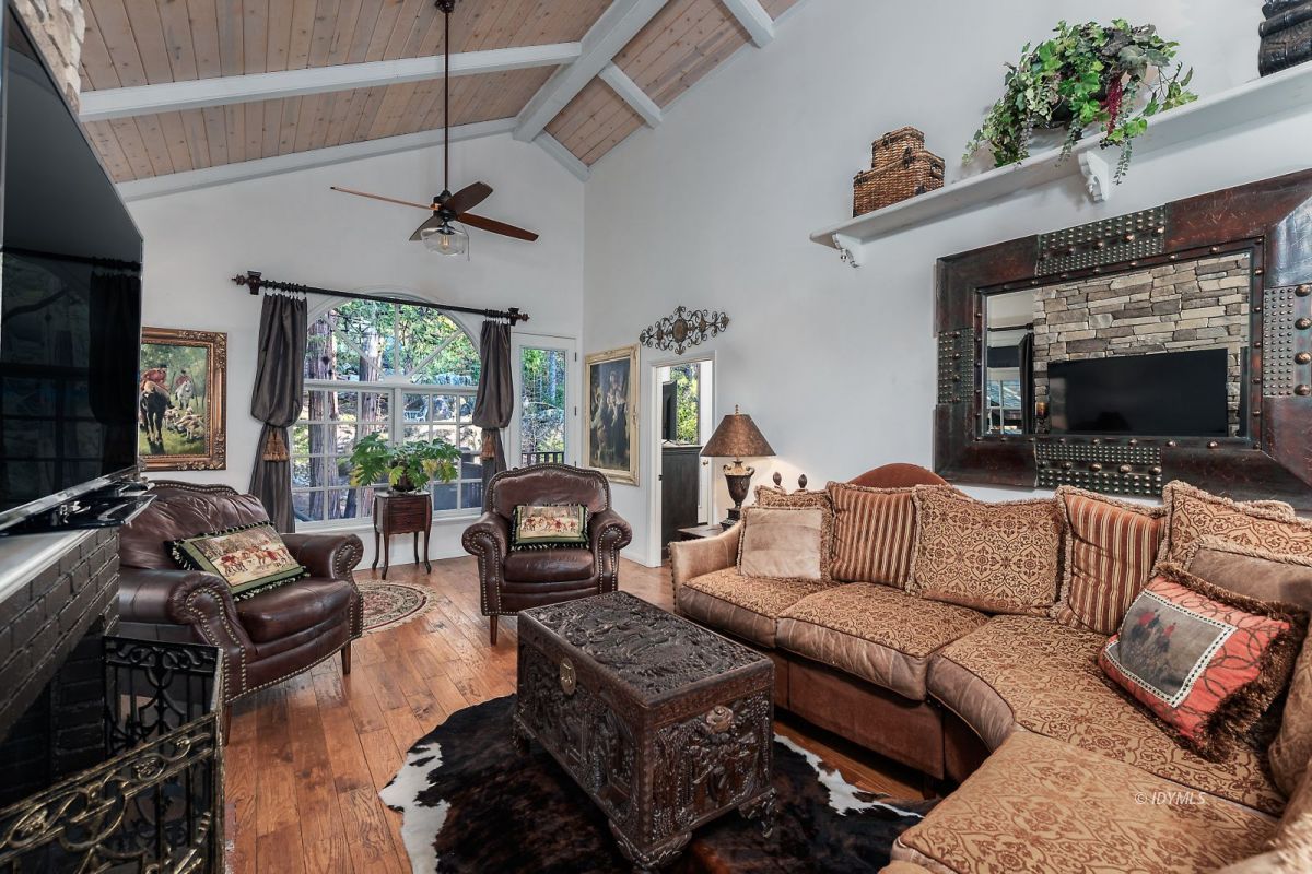 52595 Idyllmont Road Idyllwild, CA 92549 - Photo 44 of 58 a living room with furniture a flat screen tv and a fireplace