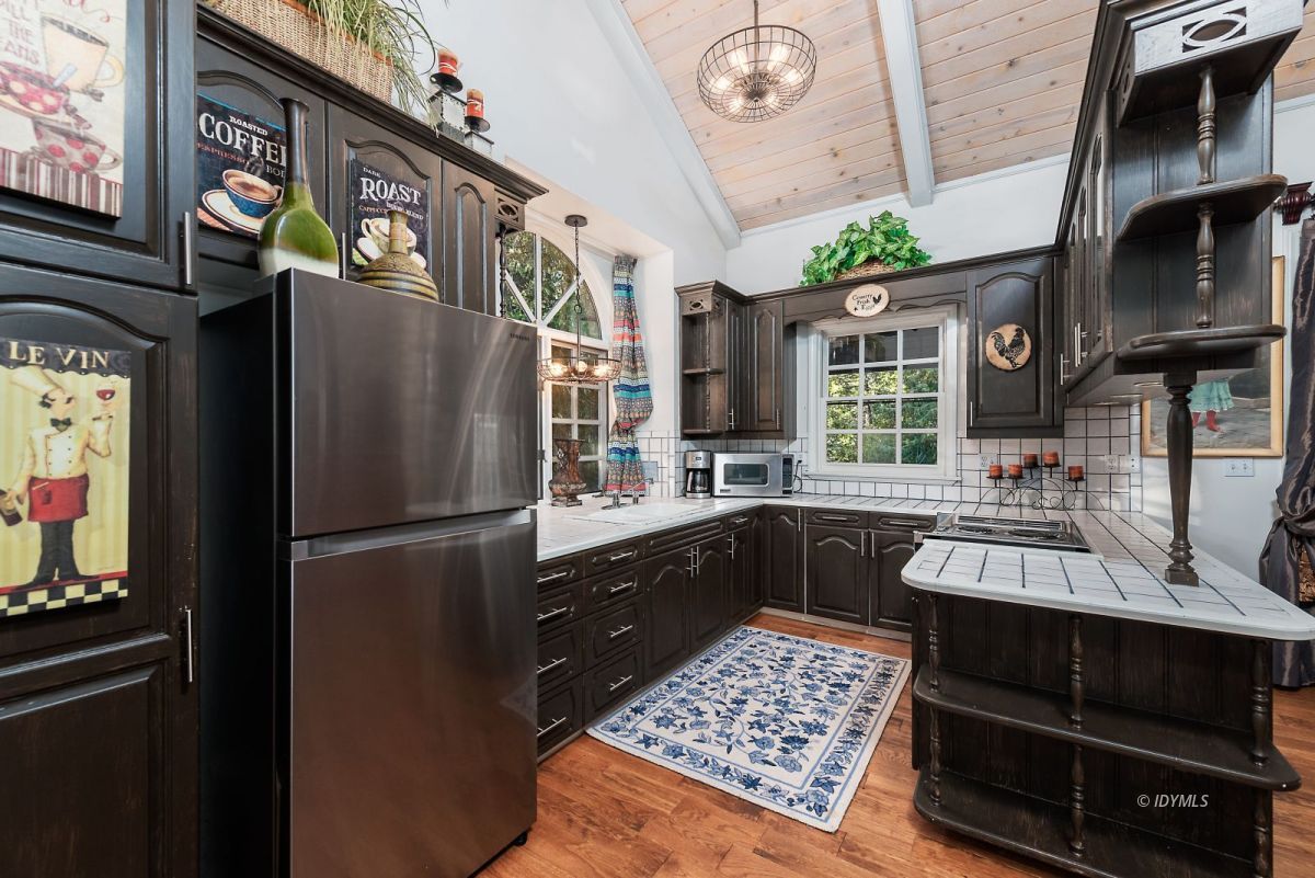 52595 Idyllmont Road Idyllwild, CA 92549 - Photo 48 of 58 a kitchen with stainless steel appliances granite countertop a refrigerator a stove and a sink
