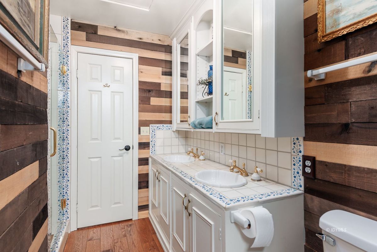 52595 Idyllmont Road Idyllwild, CA 92549 - Photo 51 of 58 a bathroom with a granite countertop sink and a washing machine