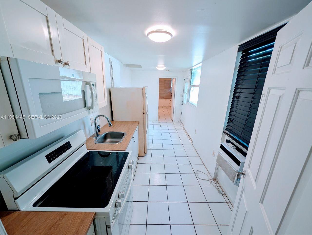 1825 Harding Street, Unit 5 Hollywood, FL 33020 - Photo 2 of 7 a view of an empty room and wooden floor