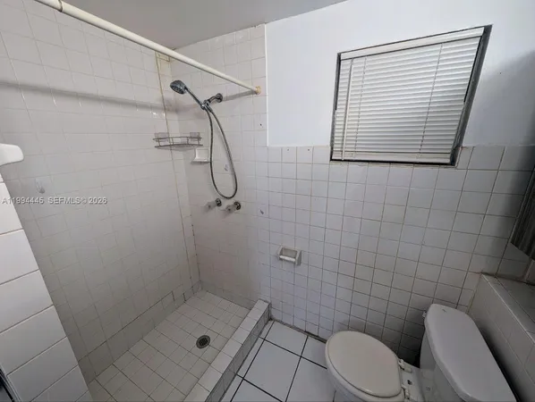 a bathroom with a shower a toilet and a sink