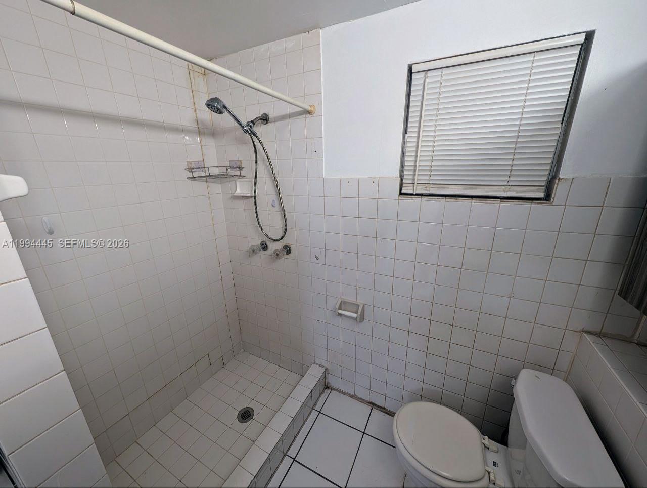 1825 Harding Street, Unit 5 Hollywood, FL 33020 - Photo 7 of 7 a bathroom with a shower a toilet and a sink