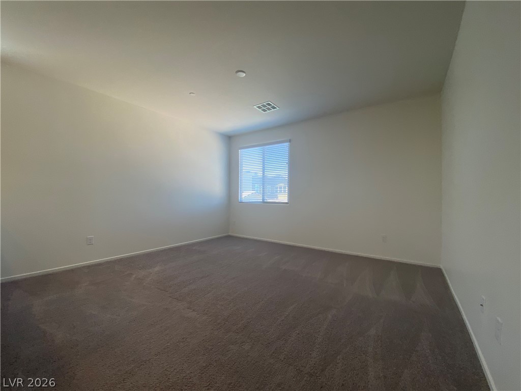 436 Cadence View Way Henderson, NV 89011 - Photo 12 of 36 An airy bedroom with fresh carpeting and a well-lit window.