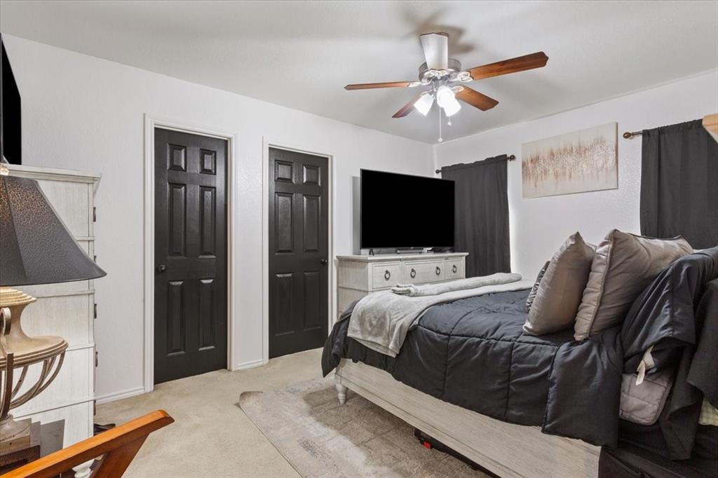 10817 Lilry Road Waco, TX 76708 - Photo 16 of 27 Bedroom featuring multiple closets, light carpet, and a ceiling fan