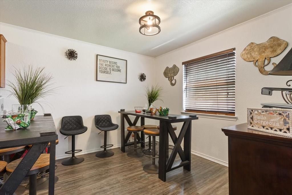 10817 Lilry Road Waco, TX 76708 - Photo 10 of 27 Dining area with dark wood finished floors and a textured ceiling