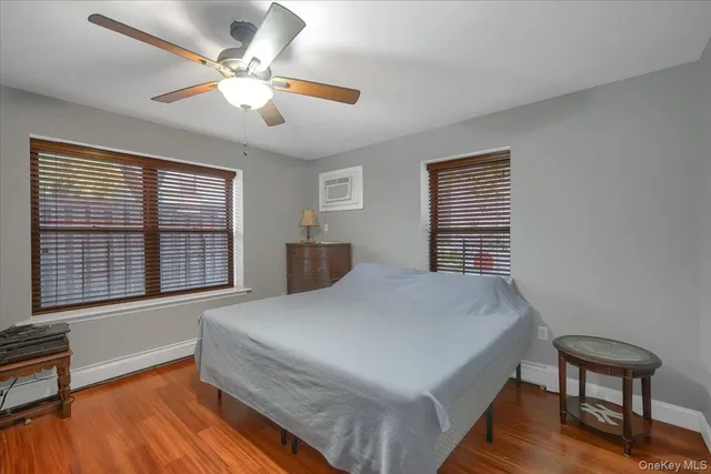 a spacious bedroom with a bed and a chandelier