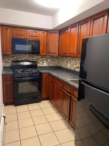 a kitchen with stainless steel appliances a stove a sink and a microwave