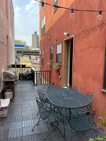a view of a balcony with table and chairs