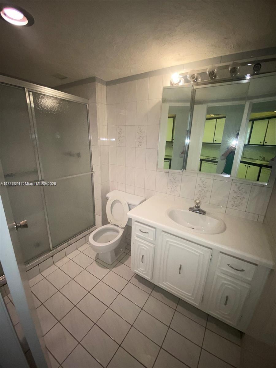Inverrary Lauderhill, FL 33319 - Photo 13 of 14 a bathroom with a granite countertop sink toilet and shower