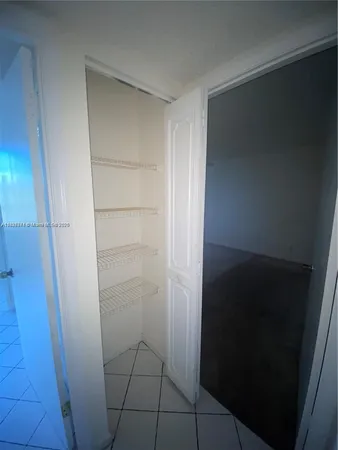 an empty room with a empty space and windows