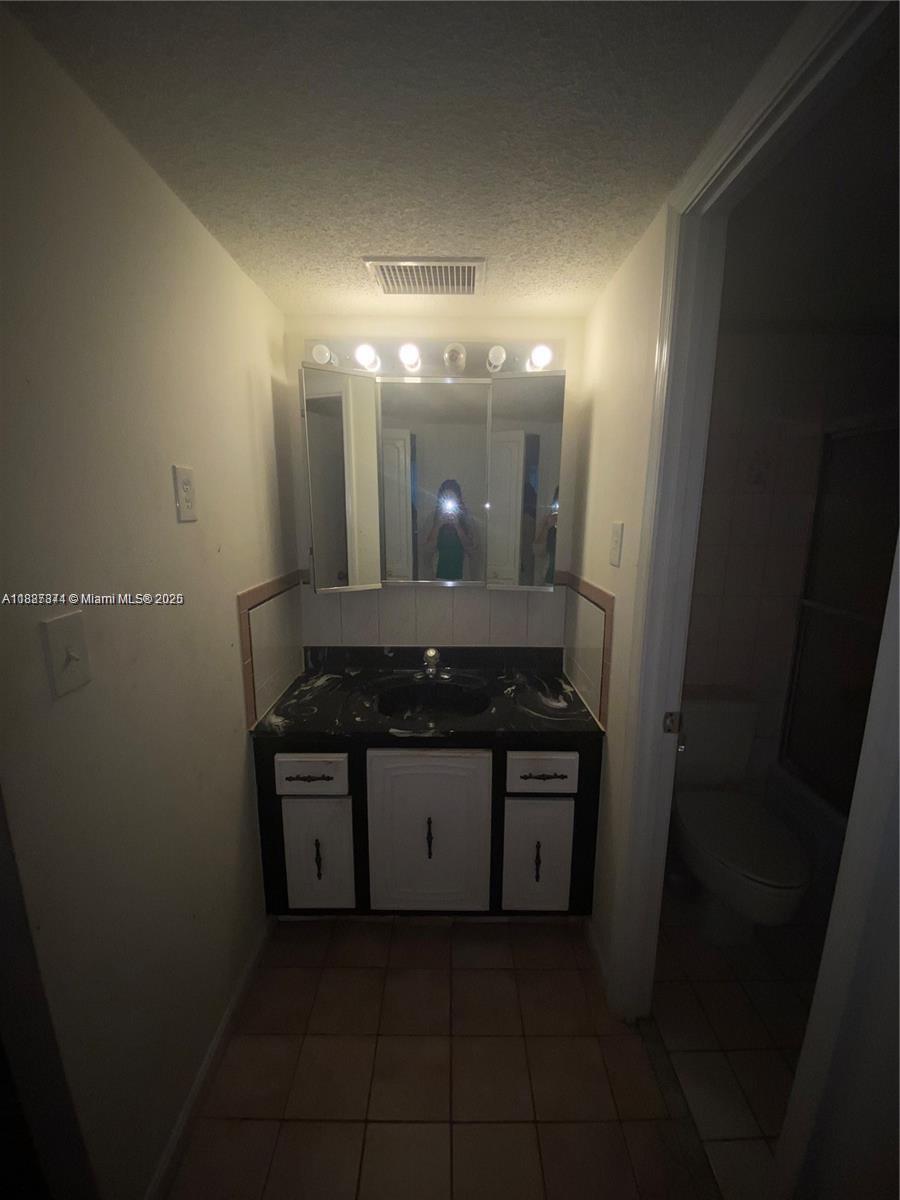 Inverrary Lauderhill, FL 33319 - Photo 10 of 14 a bathroom with a sink and a mirror