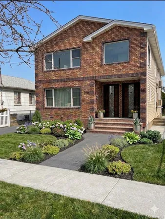 a front view of a house with a yard