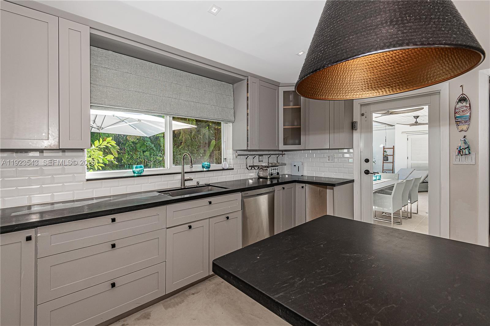 375 Harbor Court Key Biscayne, FL 33149 - Photo 16 of 58 a kitchen with stainless steel appliances granite countertop a sink a stove and a microwave oven