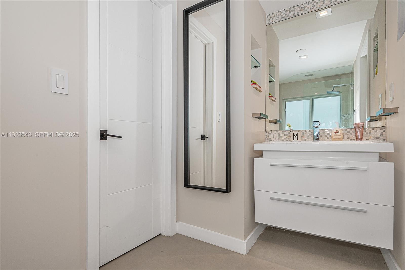 375 Harbor Court Key Biscayne, FL 33149 - Photo 38 of 58 a bathroom with a sink vanity and a mirror