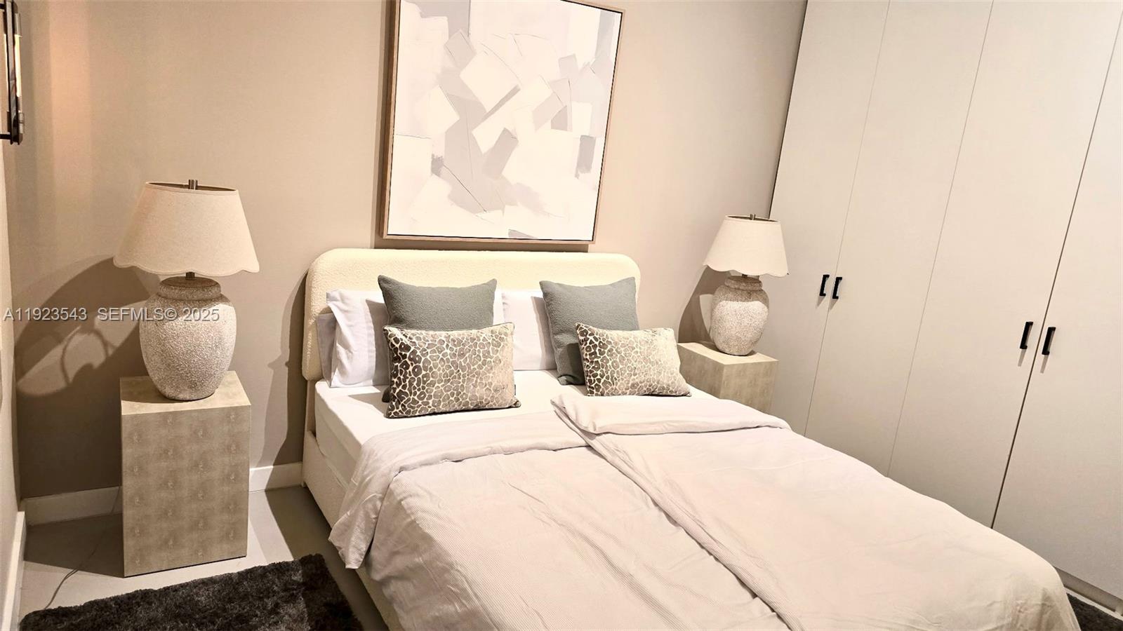 375 Harbor Court Key Biscayne, FL 33149 - Photo 43 of 58 a bedroom with a bed and a painting on the wall