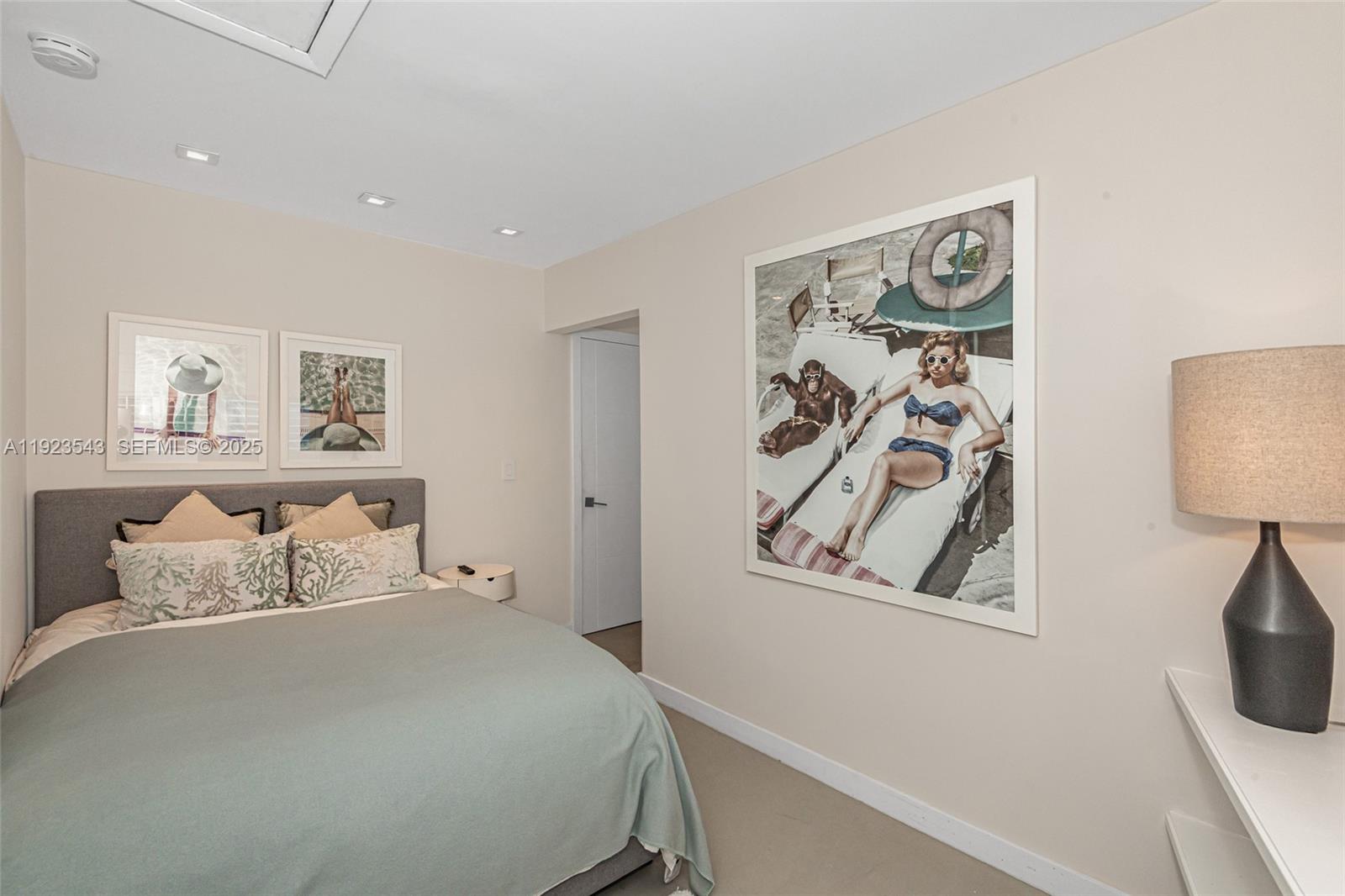 375 Harbor Court Key Biscayne, FL 33149 - Photo 44 of 58 a bedroom with a bed and painting on the wall